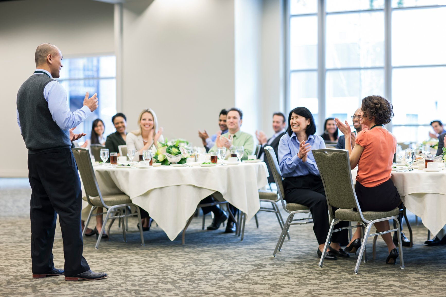 Businessman giving a talk to a group at a convention center lunch-how-to-not-be-nervous-for-a-presentation