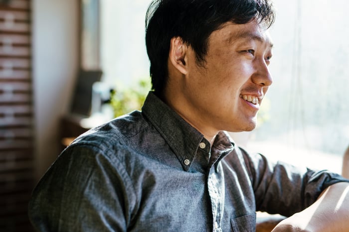 man smiling out window beside customer quote for diversity and inclusion coaching