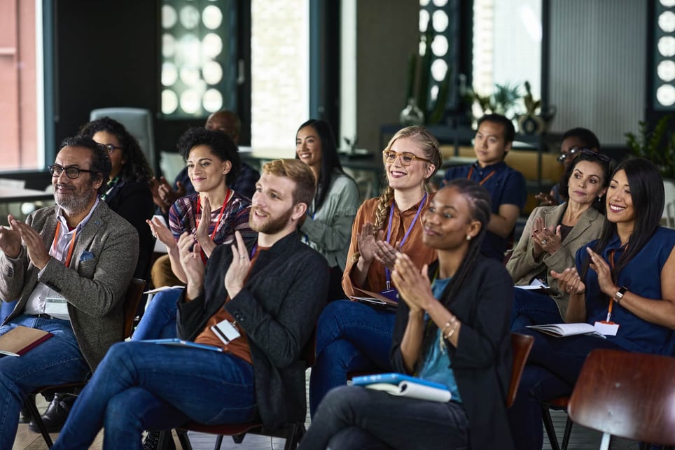 group-of-diverse-people-clapping-at-conference-how-to-be-more-persuasive