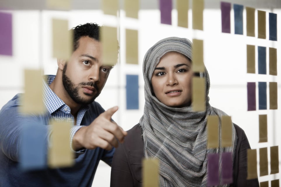 woman-with-hijab-and-man-looking-at-post-its-how-to-be-more-persuasive